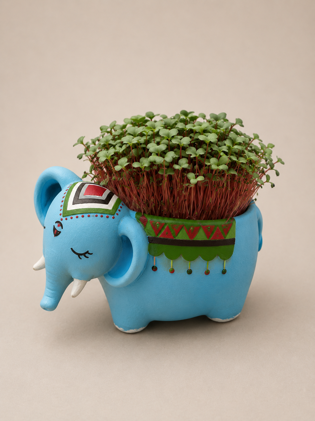 Hand-painted blue elephant planter with radish microgreens